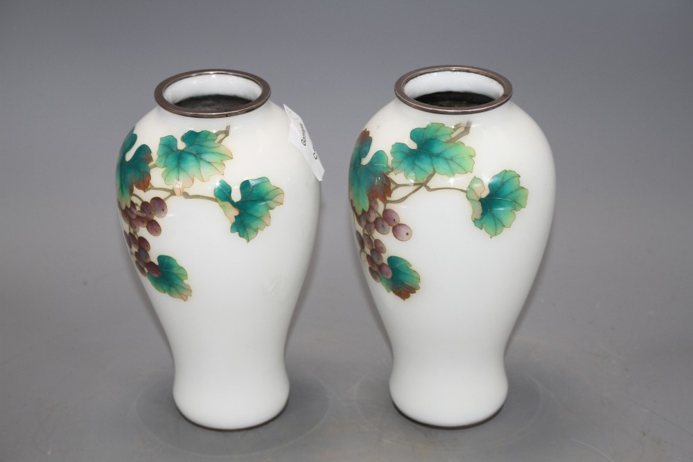 A pair of Japanese cloisonne silver wire vases, decorated with grapes on a white ground, height 18.5cm